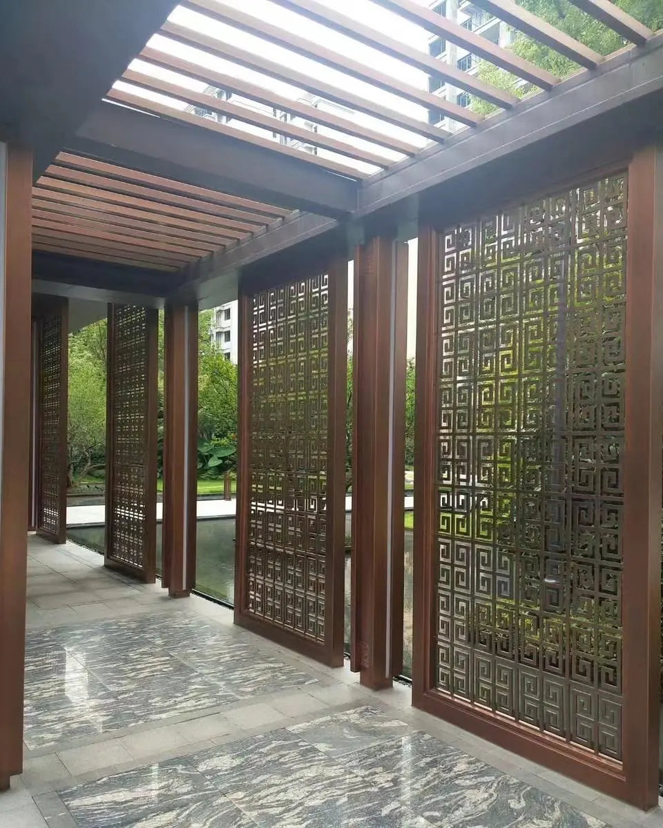 316 marine-grade stainless steel laser-cut screen installed in a villa courtyard with PVD bronze finish