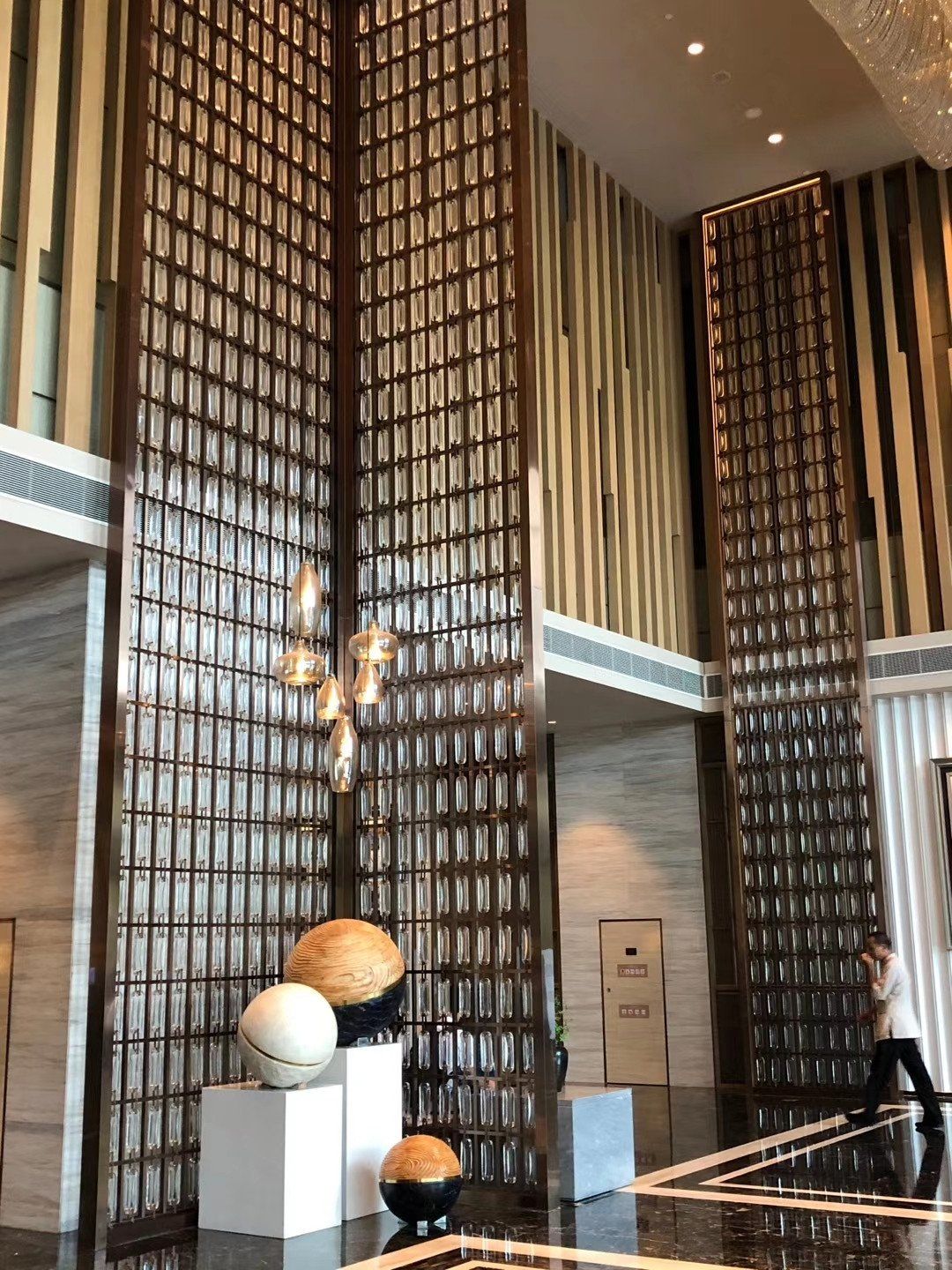 Our CNC laser-cut stainless steel geometric screen used in a premium interior.