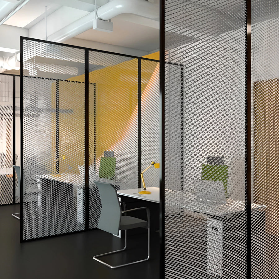 Black framed expanded stainless mesh dividers screening a workstation in an open-plan office