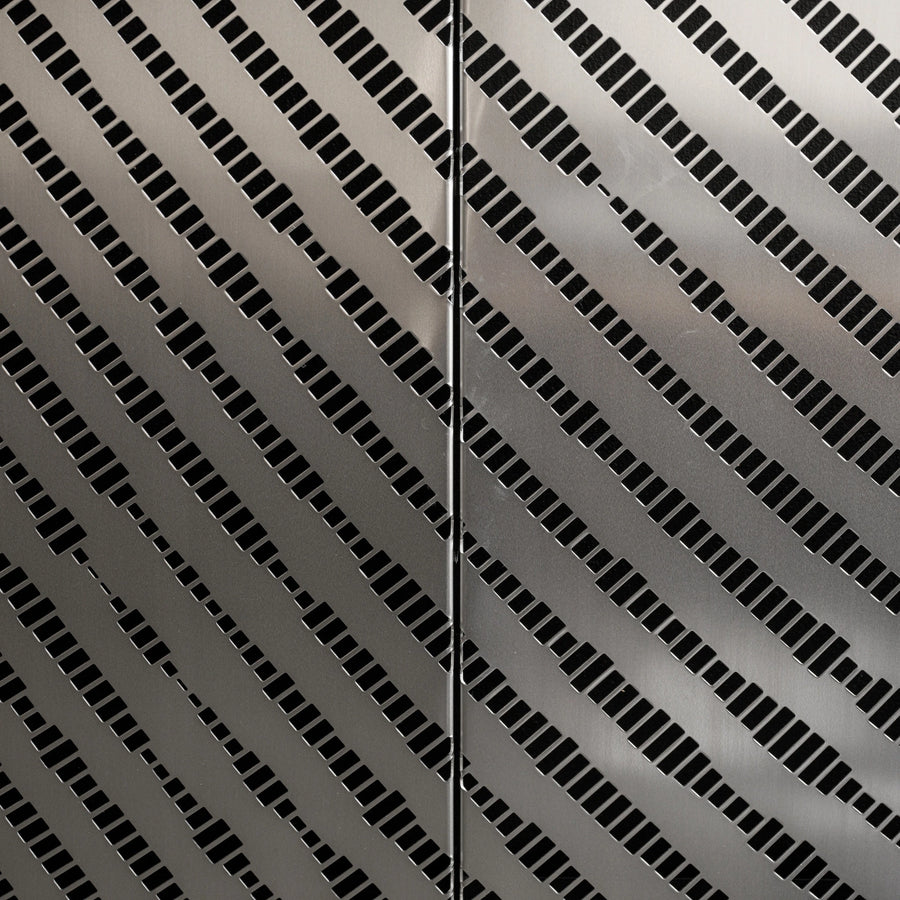 Close-up of perforated stainless steel panel, showing precise hole pattern and brushed finish.