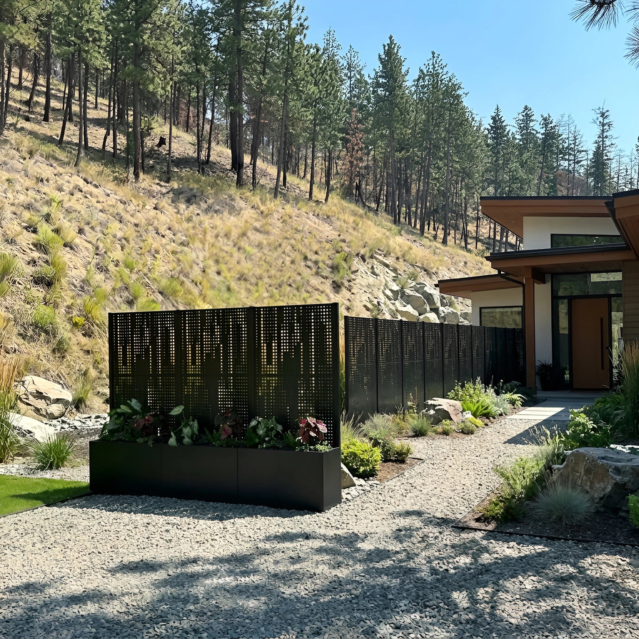 Stainless steel outdoor privacy screen installed in a landscaped courtyard, afternoon light casting layered-silhouette pattern shadows across stone paving.