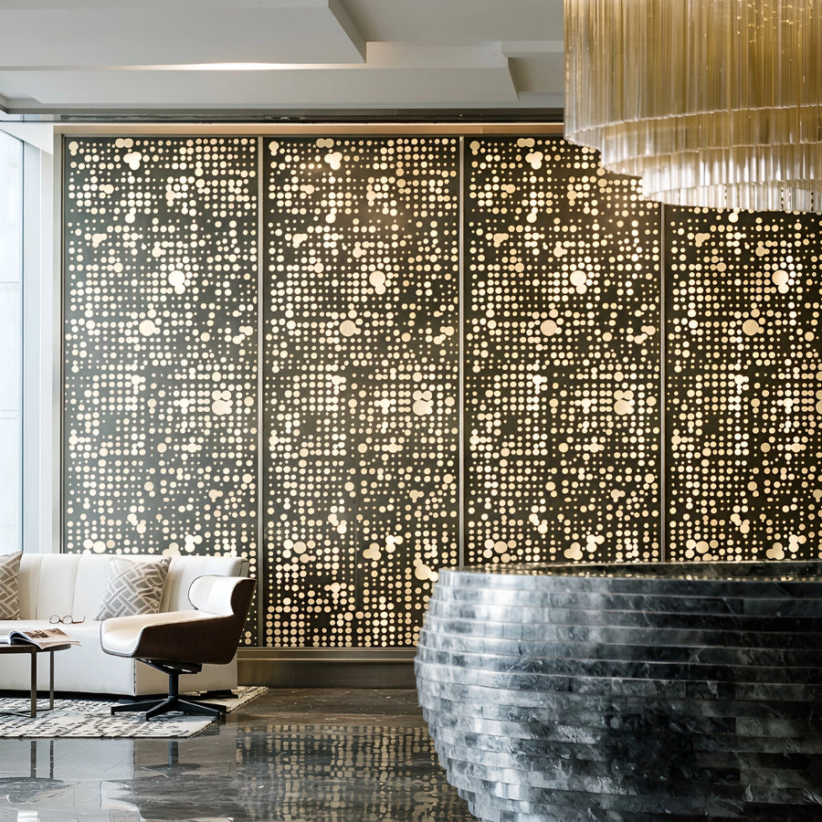 Bespoke bronze screen wall with a graduated circle perforation, backlit through art glass in a presidential suite lounge — visualization