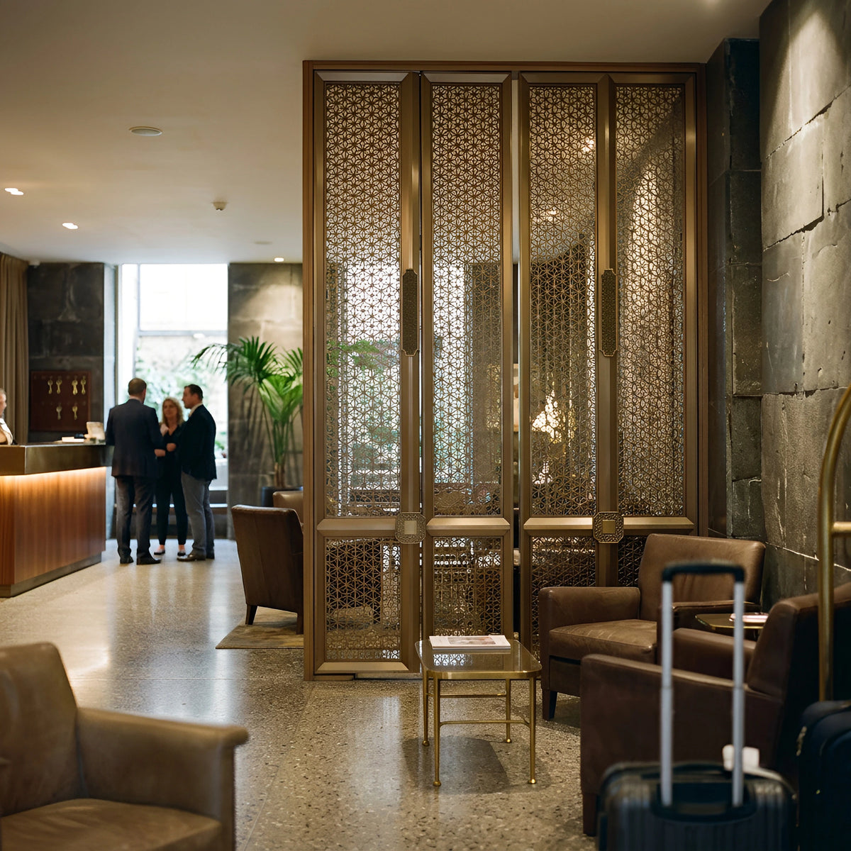 Boutique hotel lobby where brass-finished stainless screens carry the room — visualization