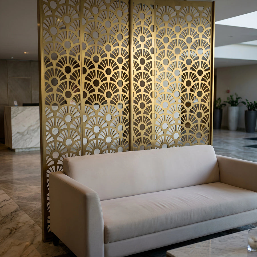 Brass floral fan-pattern screen behind a lobby lounge sofa — visualization