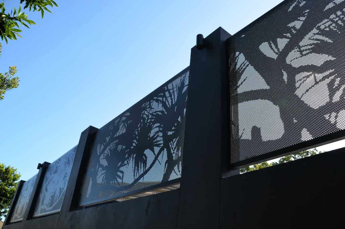 Wide outdoor view from a swimming pool showing a patterned privacy screen in context.