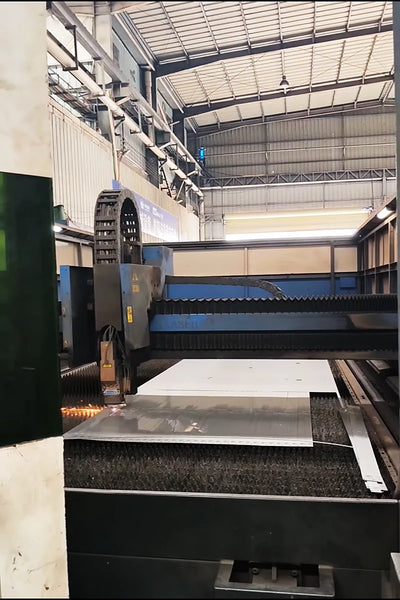 Laser cutting head in operation — fiber laser at work.